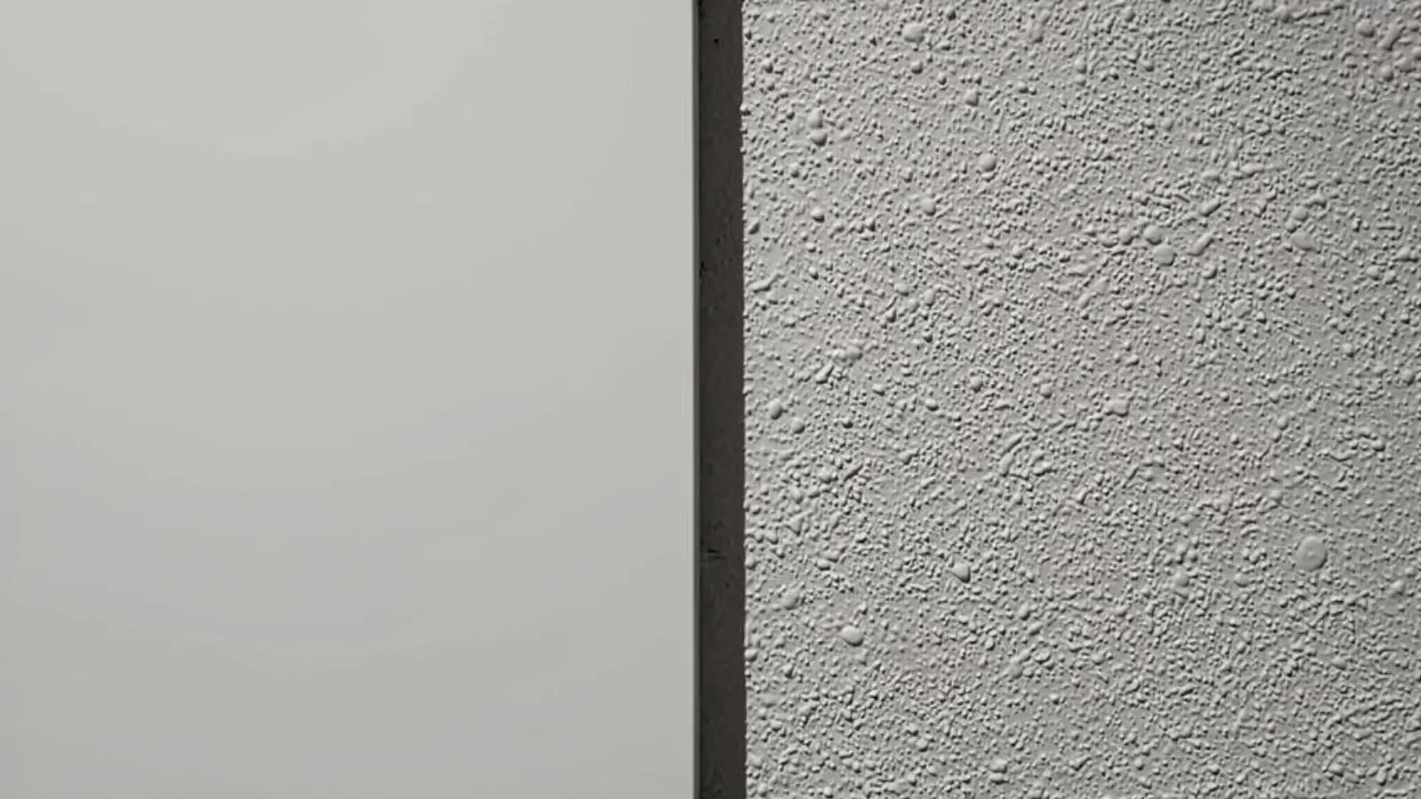 A smooth flat wall finish meeting a fine orange peel spray texture along a vertical line